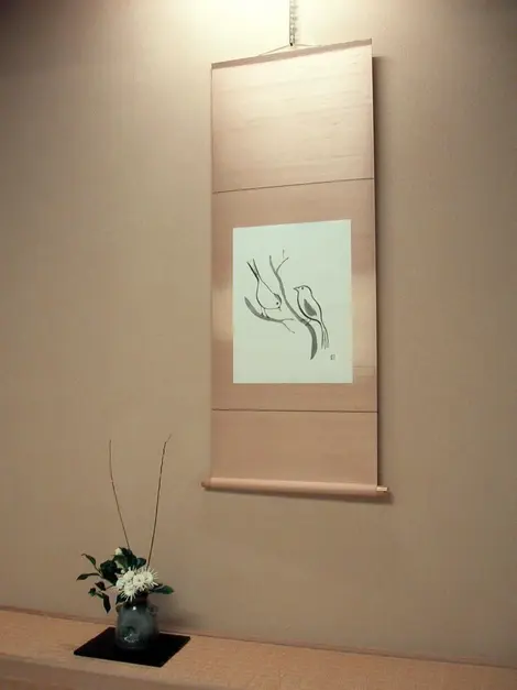 This takemonois composed of a flower arrangement and calligraphy suggesting spring
