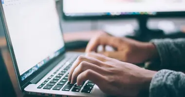 person on computer buying online train tickets japan