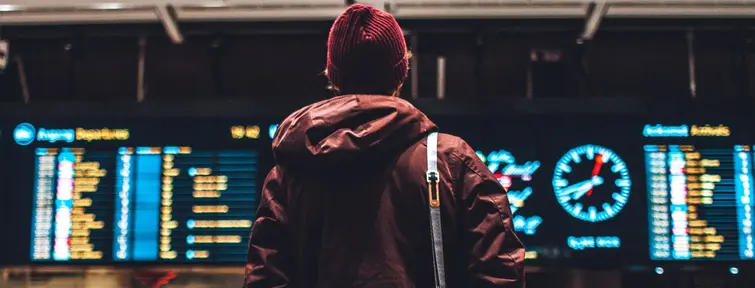Traveler in front of the billboard at the airport